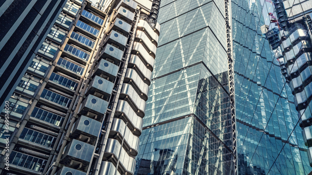 Various modern buildings in the City of London, with reflections in glass facades. Business background. Split tones.