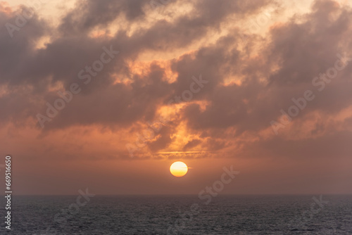 Fototapeta Naklejka Na Ścianę i Meble -  Beautiful dramatic Summer dawn over Lizard Point in Cornwall UK with lovely glowing sky and clouds