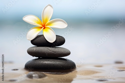 Calm and Relaxation with Spa Stones and Frangipani on Sand