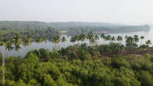 Aerial view of a beautiful landscape of an island surrounded by coconut trees in Tarkarli, Maharashtra near Goa, India photo