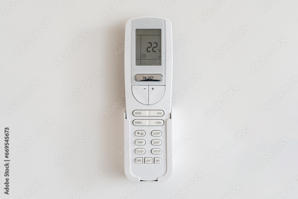 Air Conditioner Control Panel Mounted on White Wall Displays Room Temperature Air Conditioner Control Panel Mounted on White Wall Displays Room Temperature