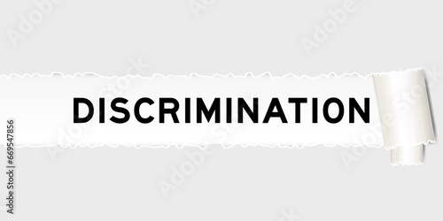 Ripped gray paper background that have word discrimination under torn part