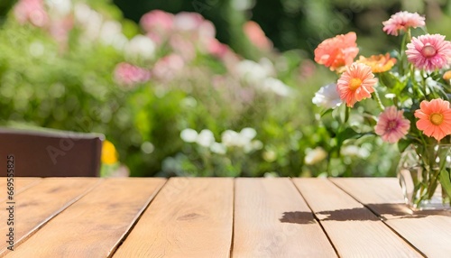 Empty wooden table top with on blurred colorful Flowers.