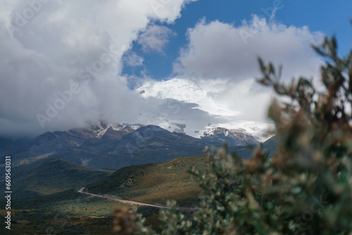 Mountain landscape with snow-capped peaks in the clouds