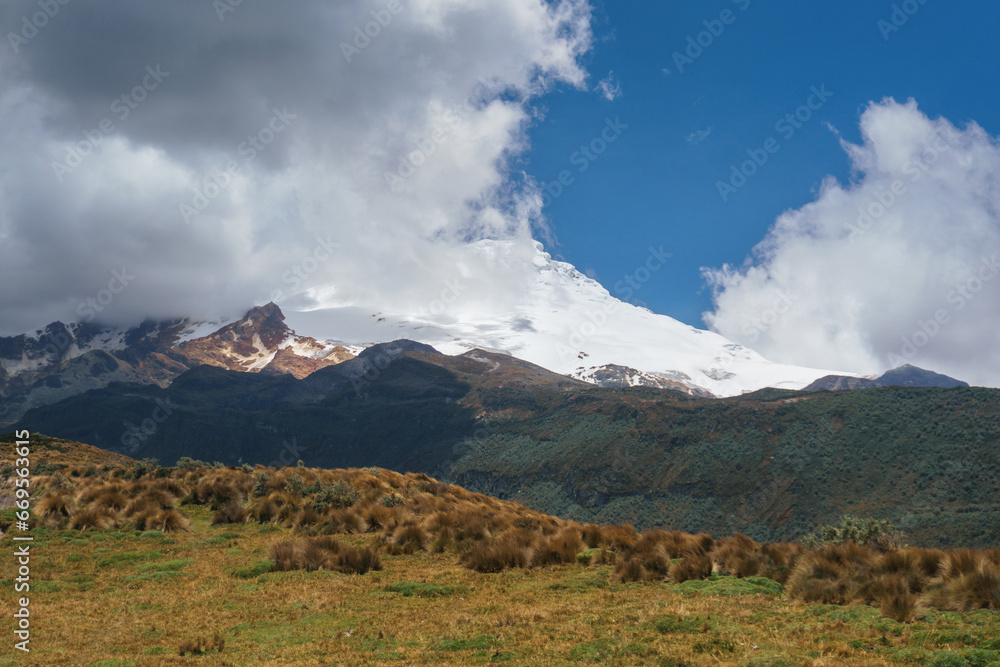 Mountain landscape with snow-capped peaks in the clouds