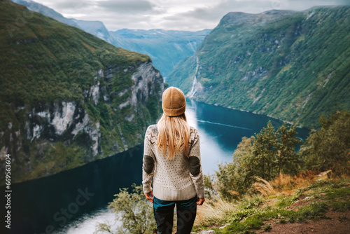 Woman traveling in Norway alone sightseeing Geiranger fjord view adventure lifestyle vacations outdoor scandinavian trip healthy lifestyle eco tourism photo