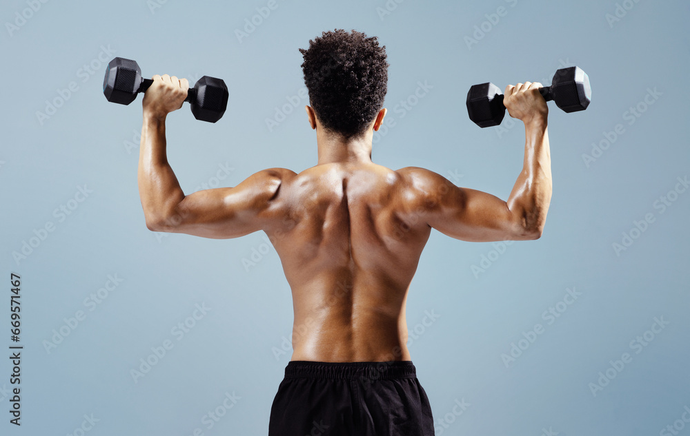 Unrecognizable sportsman showcasing muscular back while exercising with dumbbells, studio Unrecognizable sportsman showcasing muscular back while exercising with dumbbells, studio