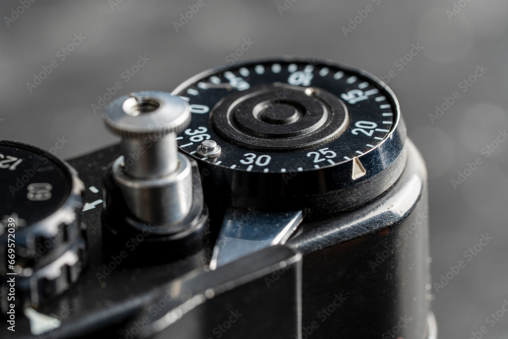 Settings mechanism on mirror analog film camera. Rotation, using mechanical wheel. Vintage photo camera, 35mm film, made in USSR, closeup Settings mechanism on mirror analog film camera. Rotation, using mechanical wheel. Vintage photo camera, 35mm film, made in USSR, closeup