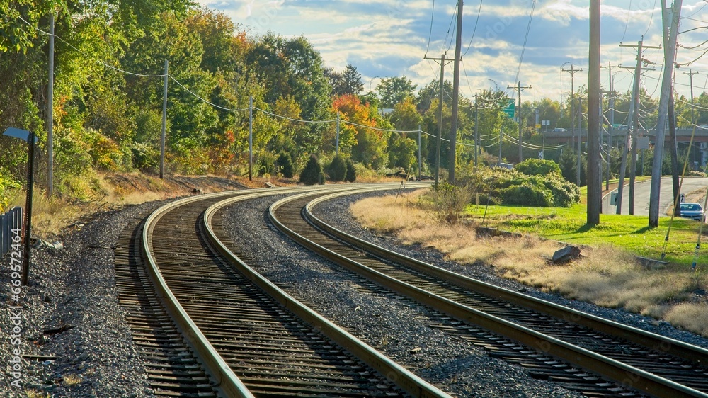 curve in railroad track under bright afternoon sunligh curve in railroad track under bright afternoon sunligh