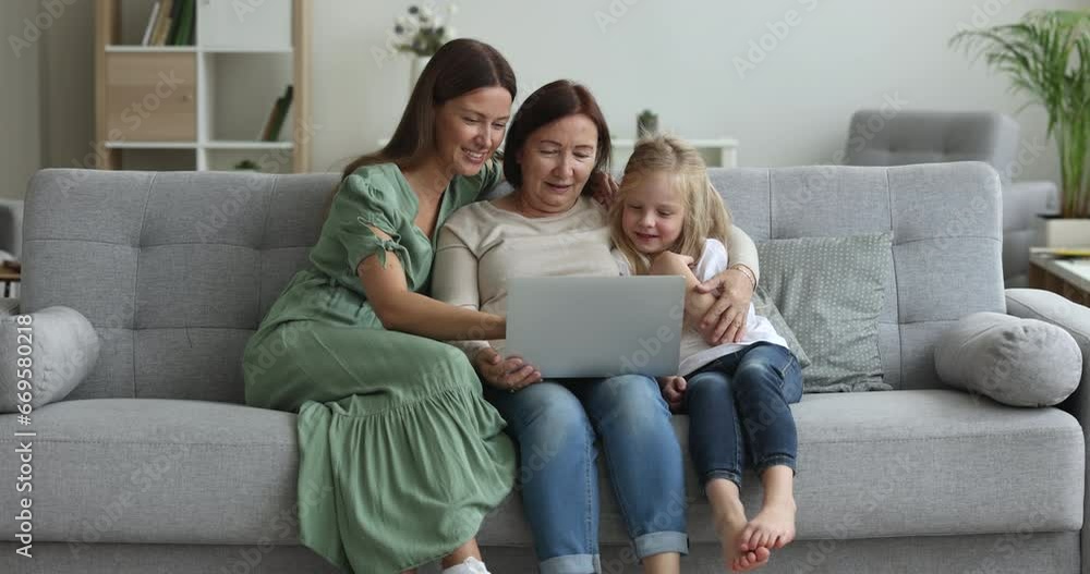 Positive focused child, mom and grandma using laptop, internet technology at home together, browsing social media on computer, shopping online with ecommerce application, service, watching content Positive focused child, mom and grandma using laptop, internet technology at home together, browsing social media on computer, shopping online with ecommerce application, service, watching content