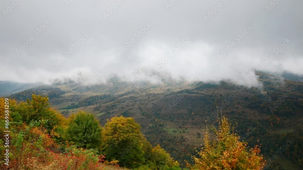Colorful autumn landscape of clouds descending from the mountains. High quality FullHD footage Colorful autumn landscape of clouds descending from the mountains. High quality FullHD footage