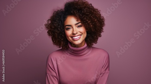 Young beautiful mixed race woman with black curly hair posing isolated on purple plain background. Looking at camera with a smile