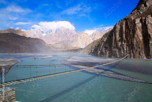 Suspension Hussaini bridge in Passu, Upper Hunza. Dangerous scary bridge, Karakoram mountains and Hunza river. 