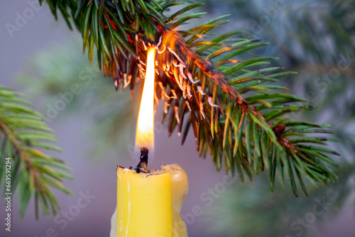 A branch of a Christmas tree caught fire from a candle, a fire due to non-compliance with safety rules photo