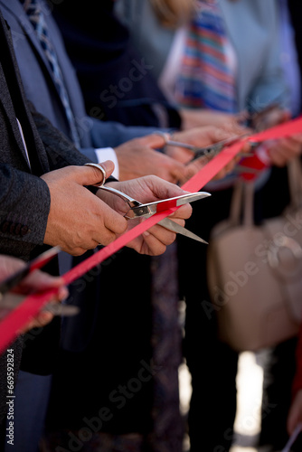 Businessmen hands cutting red ribbon close-up, new project, opening ceremony, stock footage
