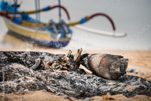 People burns waste on the beach and makes a lot of smoke which can cause air pollution. Concept for environmental damage, global warming, bad air quality, smog, climate change, ozone hole. photo