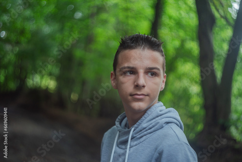 Cute little curious boy in green nature waiting for magic. Inquisitive childhood.
