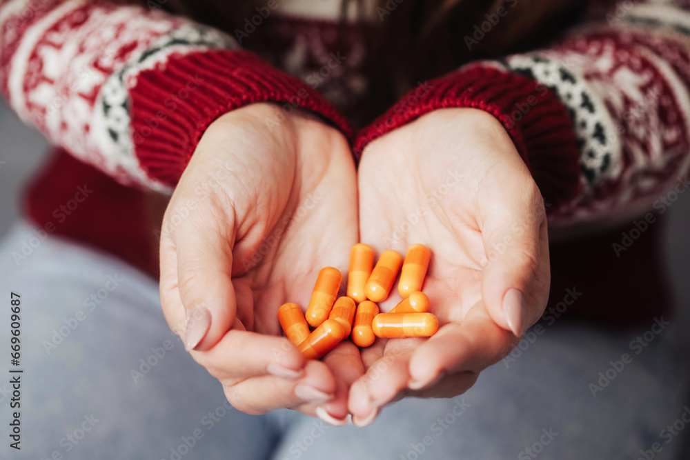 Woman holding pills. Drugs on hands. Capsules inside hands. Medical background. Sick girl with her medicine. Vitamins and minerals for diet supplementation. Woman holding pills. Drugs on hands. Capsules inside hands. Medical background. Sick girl with her medicine. Vitamins and minerals for diet supplementation.