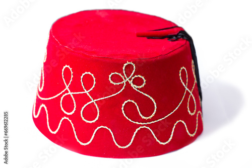 Red fez hat or tarbush hat with festive decoration isolated on the white background