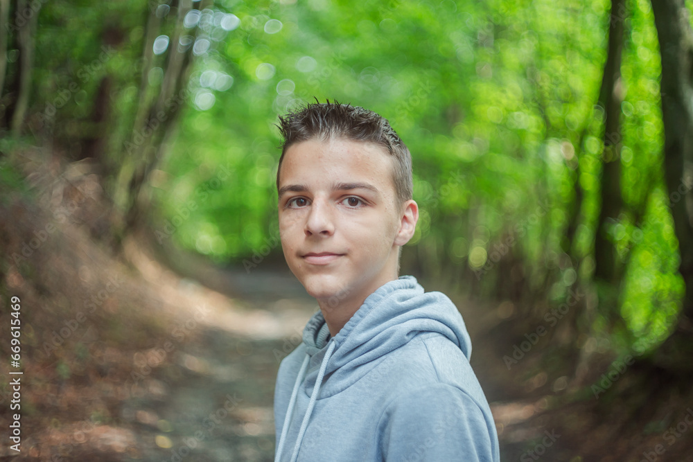 Cute little curious boy in green nature waiting for magic. Inquisitive childhood.