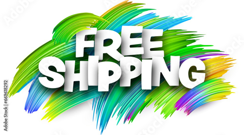 Free shipping paper word sign with green paint brush strokes over white.