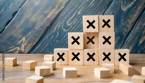 Plenty many wooden blocks full crossed marks table background. Wrong mistakes failure faults symbol icon. Defect malfunction error bug imperfection inaccuracy product manufacturing production