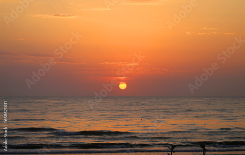 Sunset photo on the sea with waves