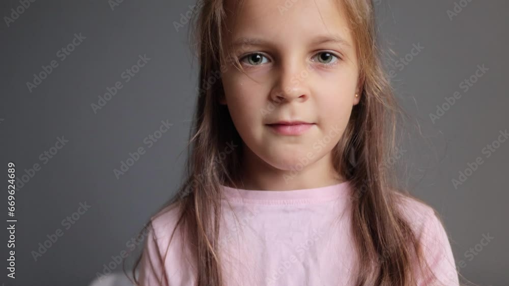 Child's medical treatment. Small kid's sickness. Domestic illness recovery. Cute female child taking medicine holding pill in hands showing tongue out looking at camera. Child's medical treatment. Small kid's sickness. Domestic illness recovery. Cute female child taking medicine holding pill in hands showing tongue out looking at camera.