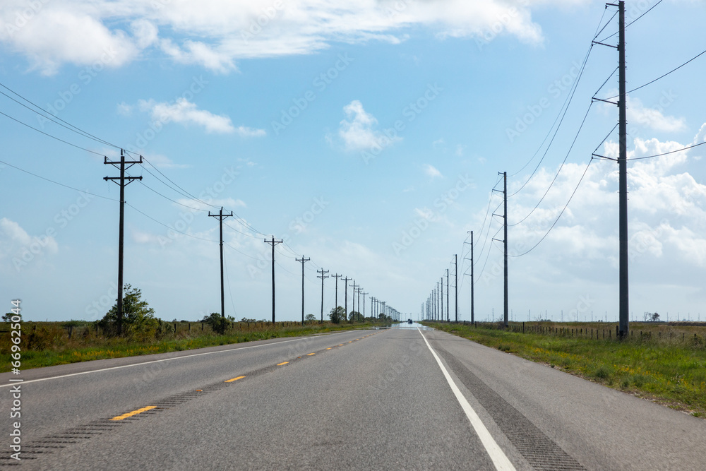 highway in texas with wooden eletrical pylons at the side, Texas, Willie