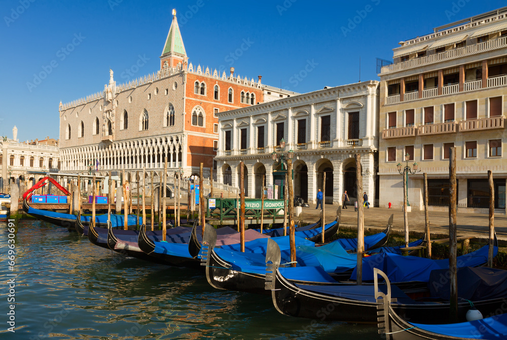 Gondolas boats and Doge palace at summer day, Venice, Italy
