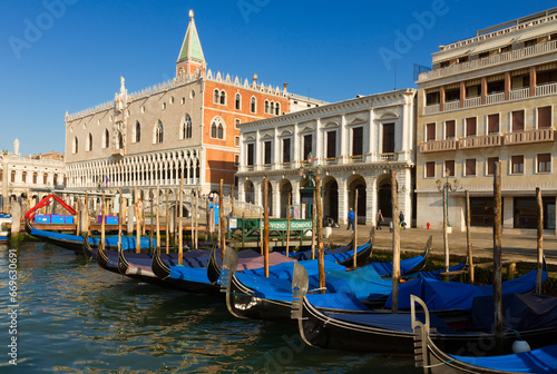 Gondolas boats and Doge palace at summer day, Venice, Italy photo