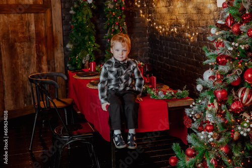 Little boy with christmas tree and gifts