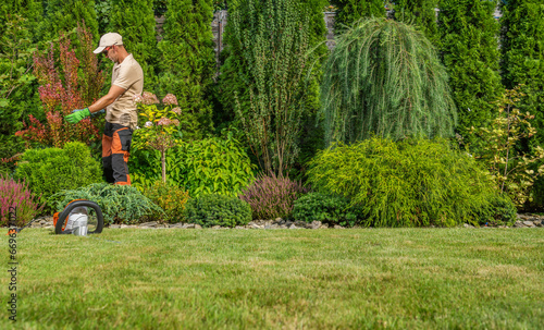 Professional Garden Worker Performing Seasonal Garden Maintenance