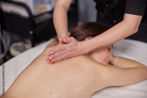 Aromatic Massage  Aroma Therapy  Aromatic Oils. Female client is enjoying aromatic massage with use essential oils at beauty spa.