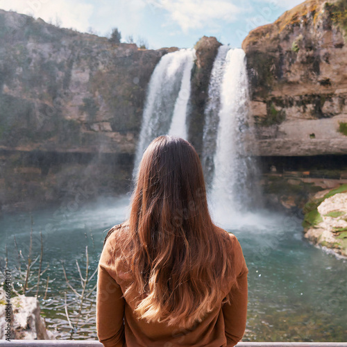 Woman overlooking waterfall