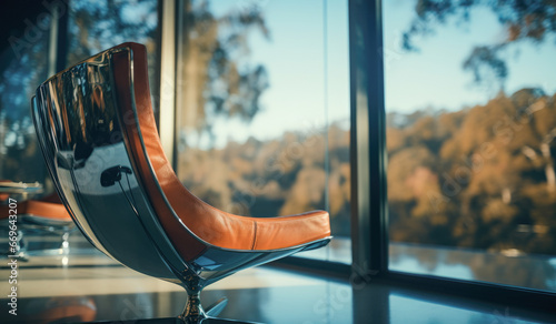 Orange leather lounge chair in front of glass window.