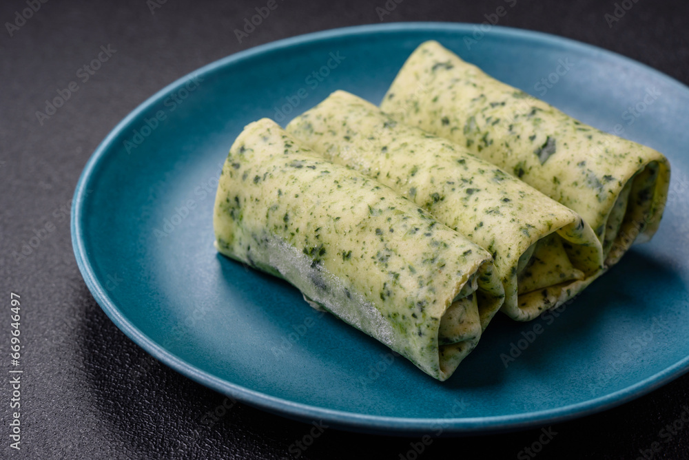Delicious fresh pancakes with spinach, cream cheese, salmon, salt and spices Delicious fresh pancakes with spinach, cream cheese, salmon, salt and spices