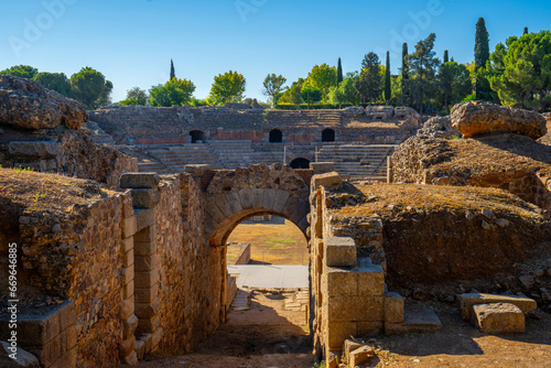 View of the restored arch entrance to the arena of the Roman Amphitheater of Mérida illuminated by the light of dawn creating shadows in its tunnels and stands. World Heritage City.