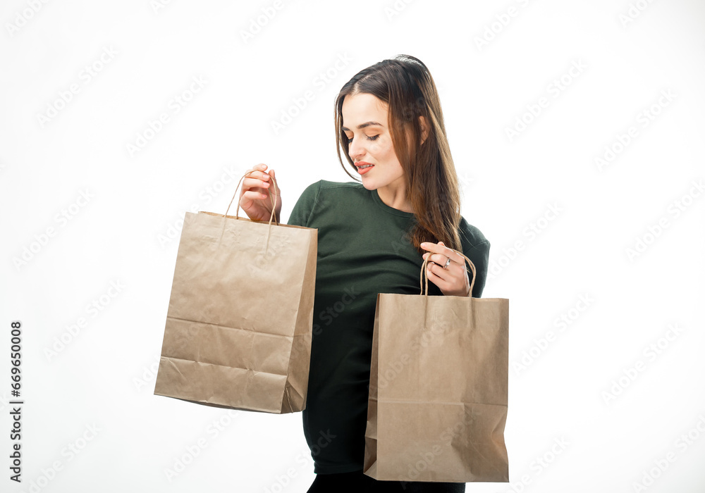 A Woman Gracefully Carrying Two Stylish Bags in Her Hands. A woman holding two brown bags in her hands