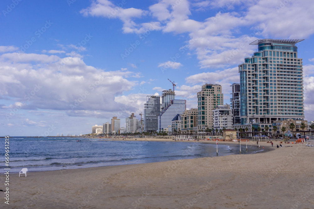 The view of Tel Aviv Bugrashov sandy beach with the Mediterranean sea coastline, and resort hotels along the watefront.