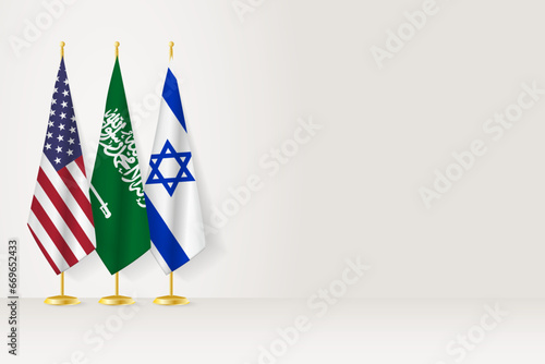 Flags of United States, Saudi Arabia and Israel stand in row on indoor flagpole.