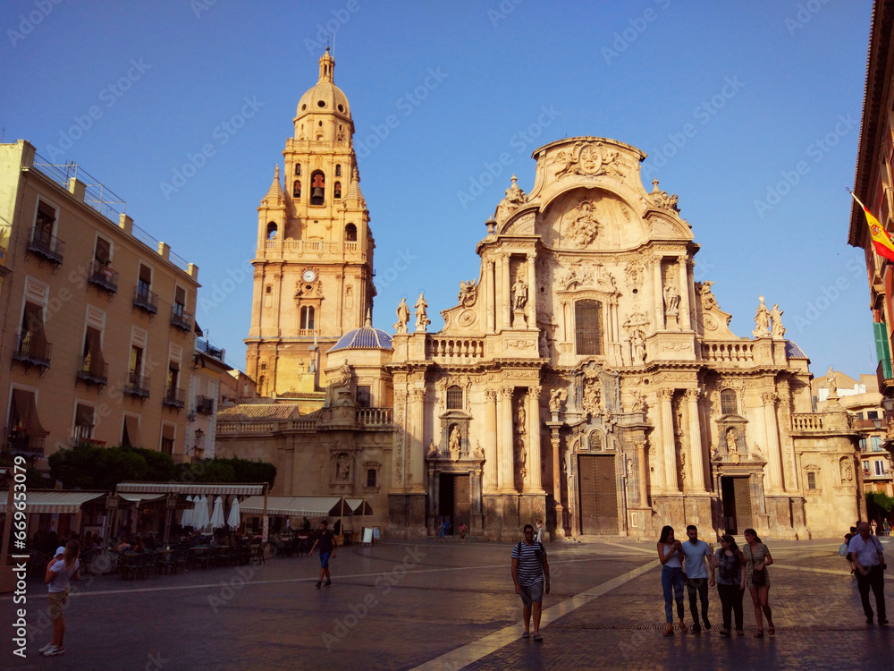 An afternoon in the square and main facade of the cathedral of Murcia, in Spain
