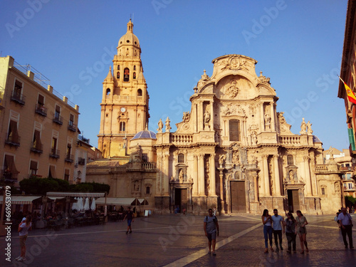 An afternoon in the square and main facade of the cathedral of Murcia, in Spain