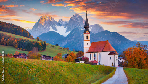 iconic picture of bavaria with maria gern church with hochkalter peak on background fantastic autumn sunrise in alps superb evening landscape of germany countryside traveling concept background photo