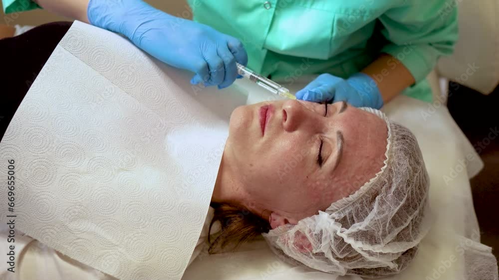 neurotoxin. collagen injections. Doctor makes multiple injections. Face lifting procedure. Adult woman in beauty clinic. Female aesthetic cosmetology in beauty salon. Cosmetology neurotoxin. collagen injections. Doctor makes multiple injections. Face lifting procedure. Adult woman in beauty clinic. Female aesthetic cosmetology in beauty salon. Cosmetology