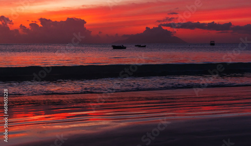 Panoramic night beach landscape  shore water under red tropical sky at sunset