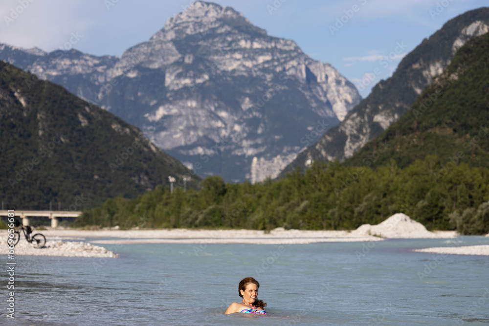 Adult Woman Cycled to the near River for a Refreshment in Summer - Carnia Italy