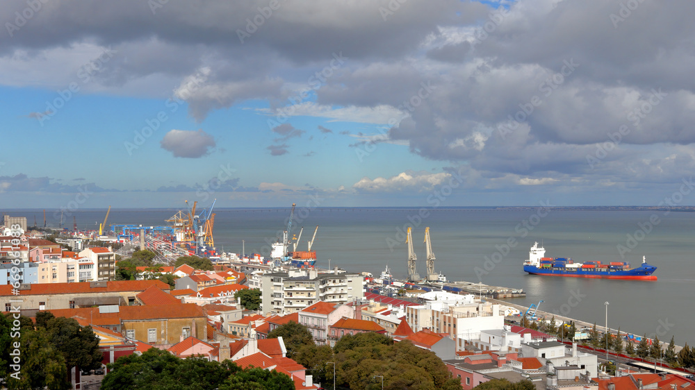Obraz premium Aerial view of Lisbon sea port, red roofs and clouds in blue sky