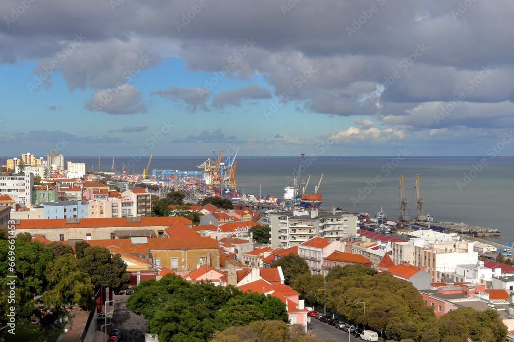 Aerial view of Lisbon sea port, red roofs and clouds in blue sky