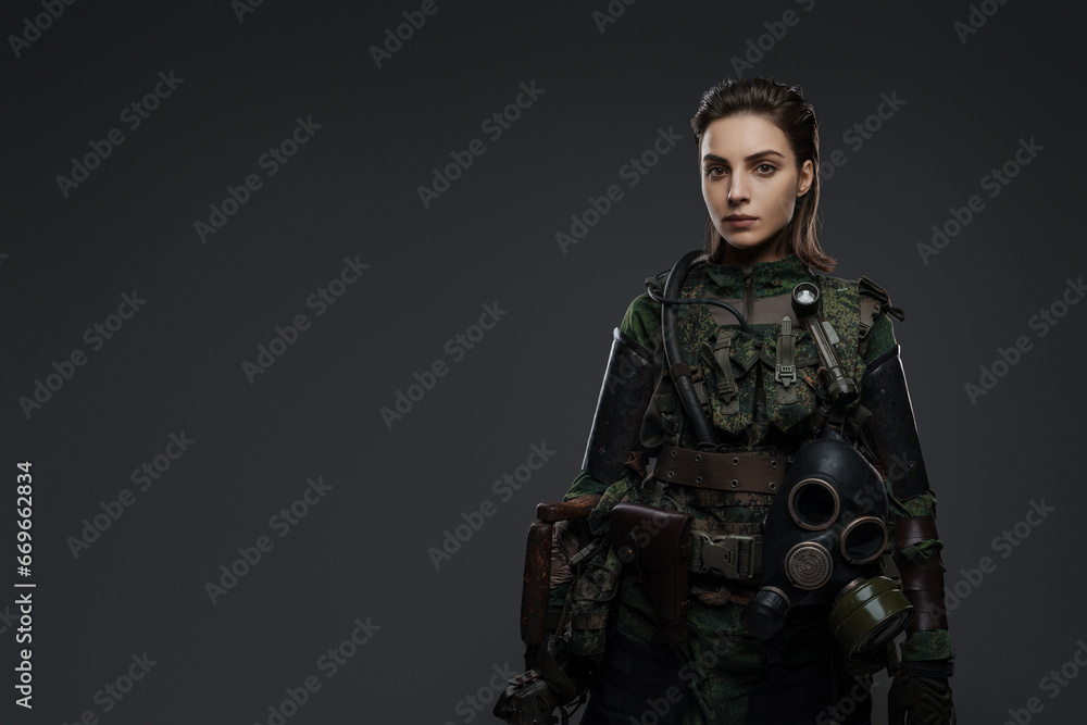 Portrait of a woman in military attire, portraying a rebel or partisan, against a gray background, depicting a Middle Eastern conflict Portrait of a woman in military attire, portraying a rebel or partisan, against a gray background, depicting a Middle Eastern conflict